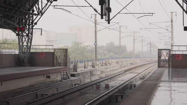 Delhi Metro Train Arriving at Station Platform in Winter Fog