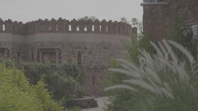 Ancient Stone Fort Architecture with Lush Greenery in India