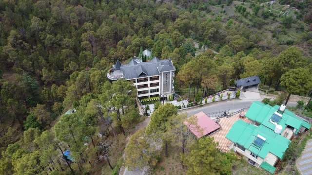 Aerial View of Mountain Resort Nestled in Dense Pine Forest