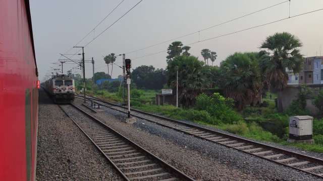 Indian Railways Express Train Passing Through Rural Landscape