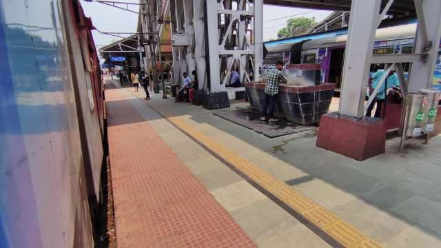 Busy Indian Railway Station Platform with Trains and Commuters