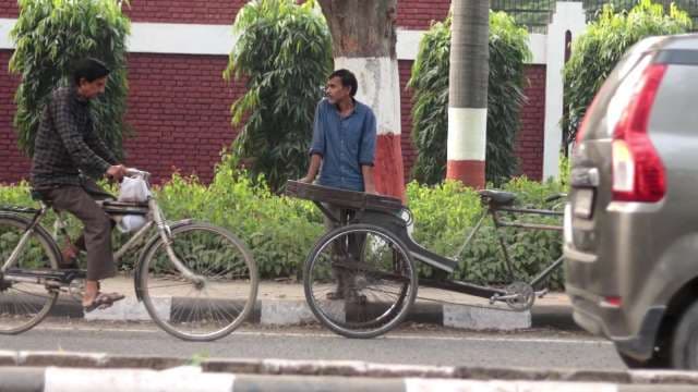 Indian Street Scene with Men Using Bicycles and Rickshaws