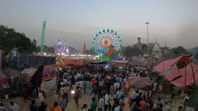 Vibrant Indian Night Fair with Illuminated Ferris Wheels and Crowds