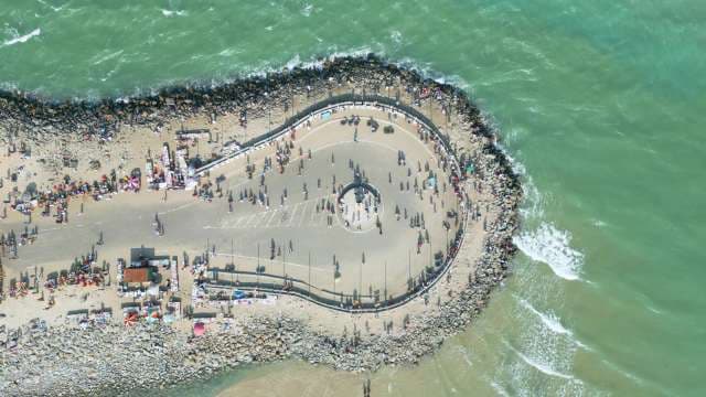 Aerial Drone View of Busy Teardrop Coastal Pier Market