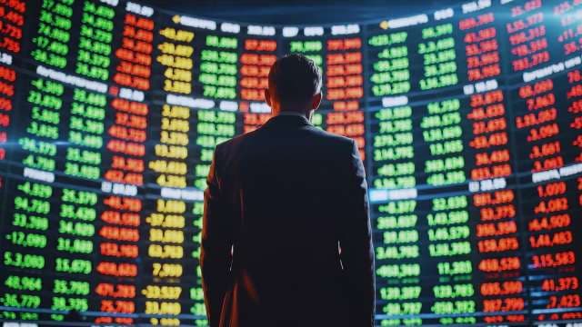 Businessman Analyzing Real-Time Stock Market Data Display