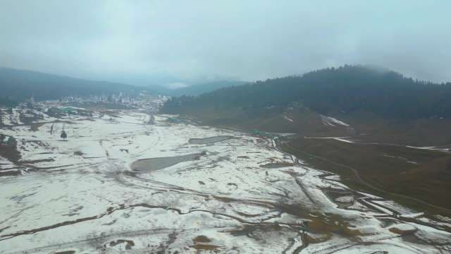 Aerial View of Snowy Gulmarg Valley and Misty Mountain Landscape