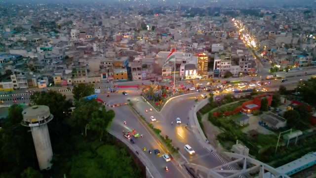 Aerial Night View of Busy Ludhiana Intersection with Indian Flag