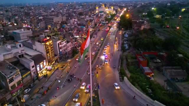 Aerial View of Indian Flag Over Busy City Traffic at Night