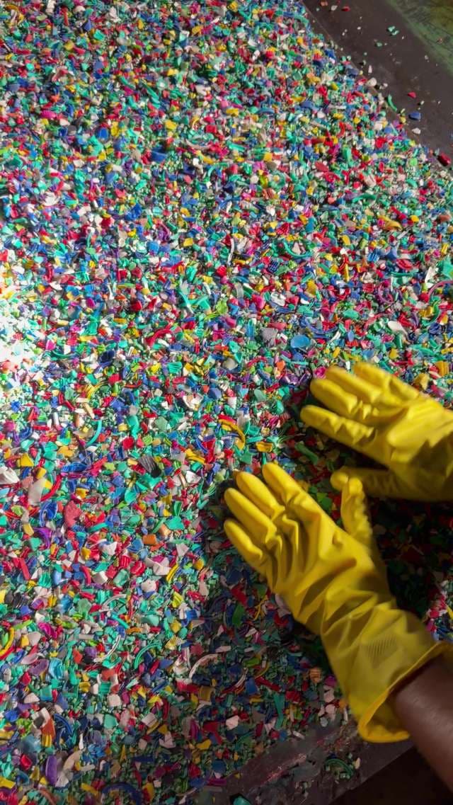 Gloved Hands Sorting Colorful Recycled Plastic Waste