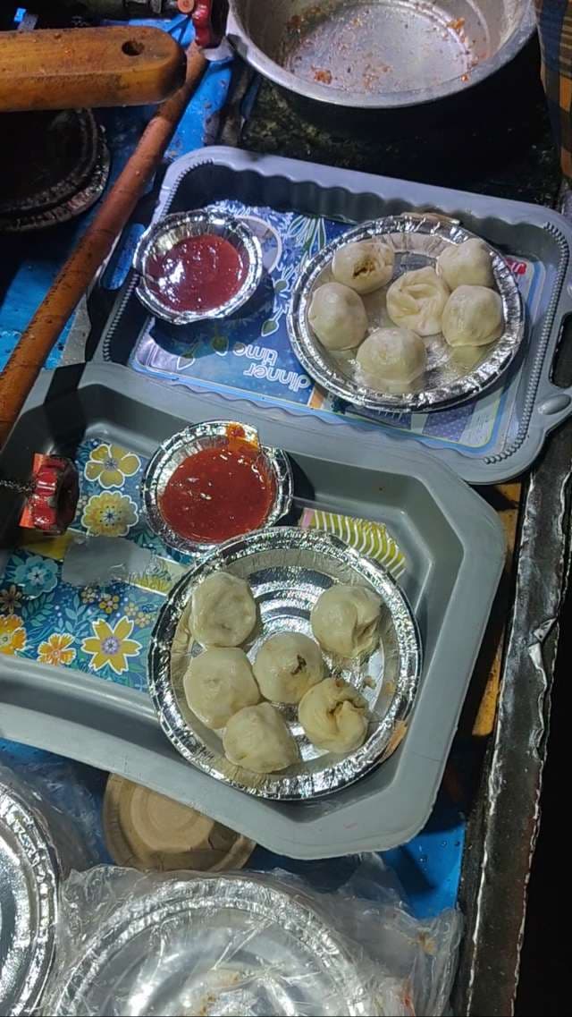 Authentic Indian Street Food Steamed Momos Served with Spicy Red Chutney