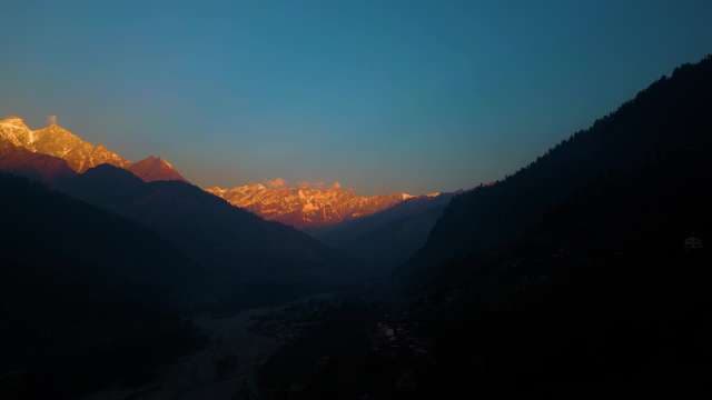 Golden Sunset over Snow Capped Mountain Peaks in Manali