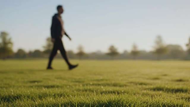 Blurred Man Walking Through Sunny Morning Park
