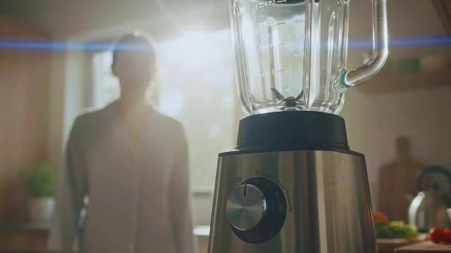 Modern Kitchen Blender with Woman Preparing Healthy Smoothie in Morning Sunlight