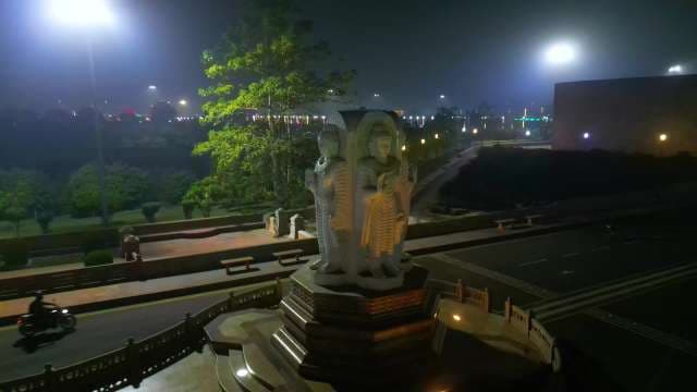 Illuminated Four-Sided Buddha Statue at Night in Lucknow