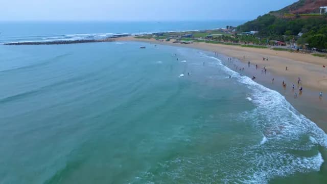 Aerial View of Rushikonda Beach with Turquoise Waves and Coastal Hills, Visakhapatnam
