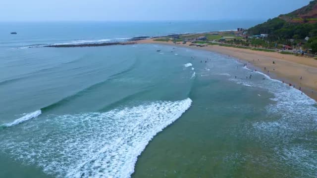 Scenic Aerial View of Waves Crashing on Coastal Tropical Beach, Visakhapatnam