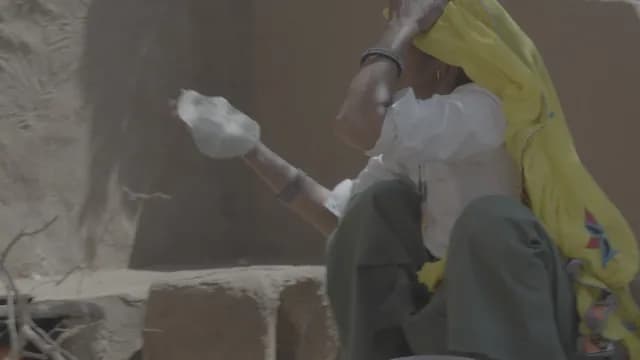 Traditional Rajasthani Woman Preparing Flatbread over Mud Stove(Chulha) in Rural Village