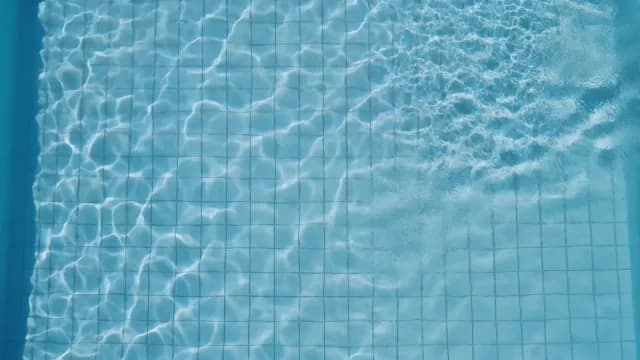 Clear Blue Swimming Pool Water Ripples and Sun Caustics Background
