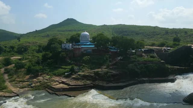 Scenic Aerial View of White Temple Beside Rushing Waterfall, Rajdari Devdari