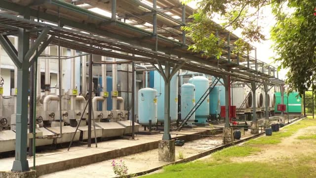 Industrial Processing Facility with Metal Pipes and Storage Tanks