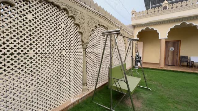 Traditional Rajasthani Courtyard with Garden Swing and Ornate Jali Architecture