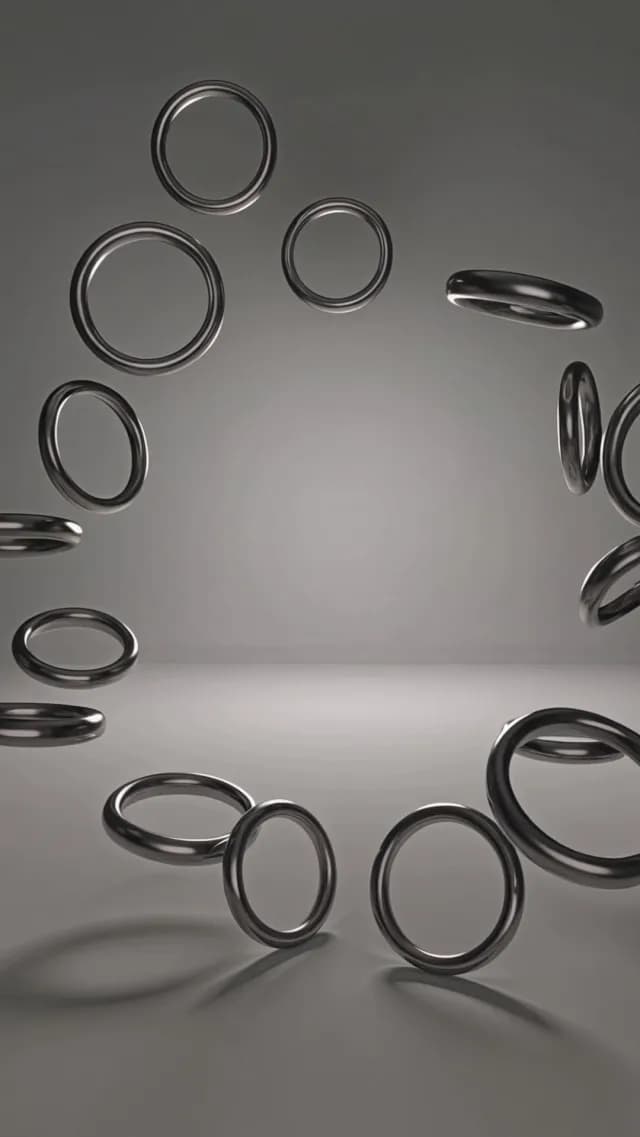 Abstract Floating Metallic Chrome Rings in Minimalist Gray Studio