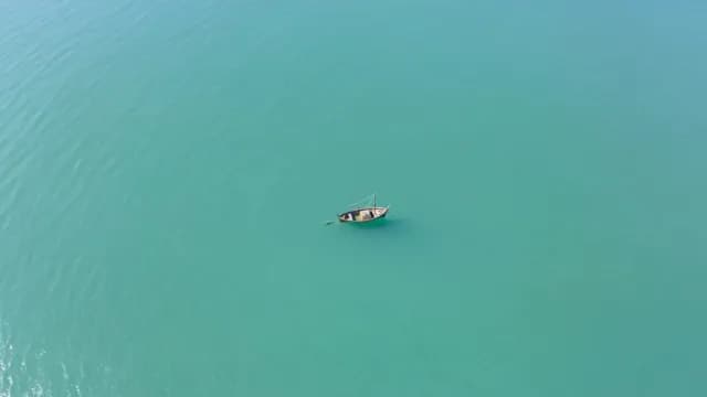 Aerial Top View of Lonely Boat in Turquoise Sea