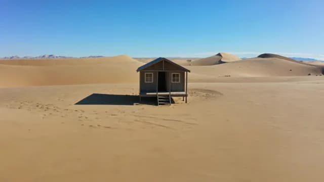 Isolated Wooden Cabin in Vast Sand Desert
