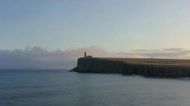 Scenic Coastal Lighthouse on High Cliff at Sunset