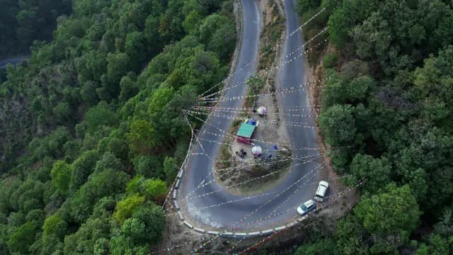 Aerial View of a Winding Himalayan Road with Buddhist Prayer Flags, Mussoorie