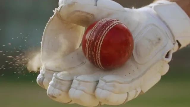 Extreme Close-up of Cricket Ball Impacting Wicket-Keeper Glove