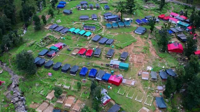 Aerial Shot of Remote Mountain Campsite With Colorful Tents Chopta, Uttrakhand