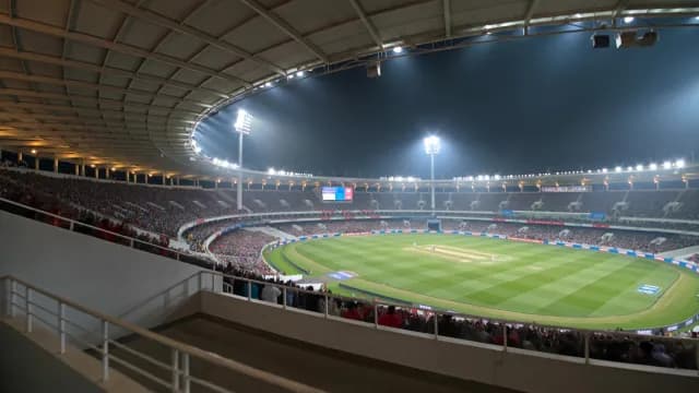 Cricket Stadium Night Match with Large Crowd Under Floodlights