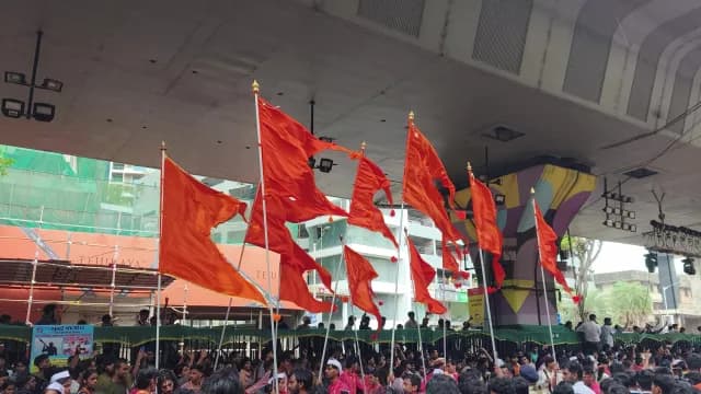 Saffron Flags Waving Above Crowd During Procession in Mumbai India