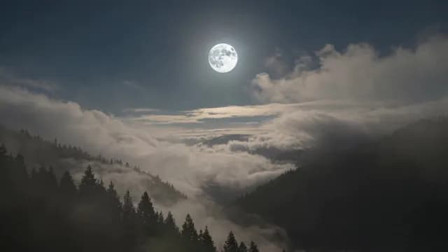 Full Moon Shining Over Misty Mountain Forest Valley