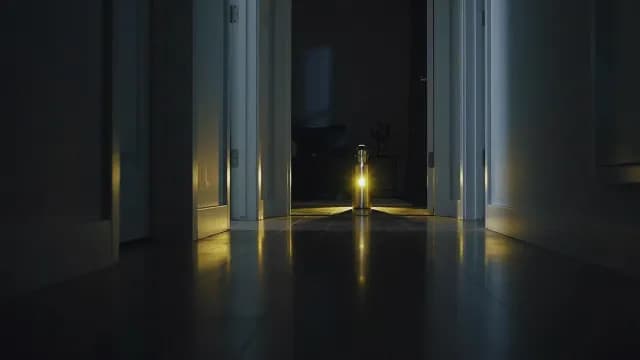Glowing Lantern Illuminating a Dark Hallway at Night