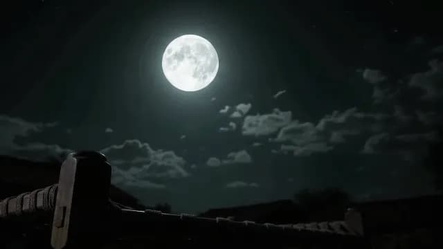 Bright Full Moon Glowing in a Dark Night Sky with Clouds