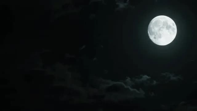 Luminous Full Moon Shining Through Dark Night Sky