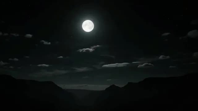 Bright Full Moon Glowing Over Silhouetted Mountain Range at Night