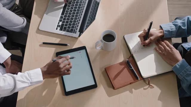 Collaborative Business Team Working with Digital Tablet Laptop and Notebook