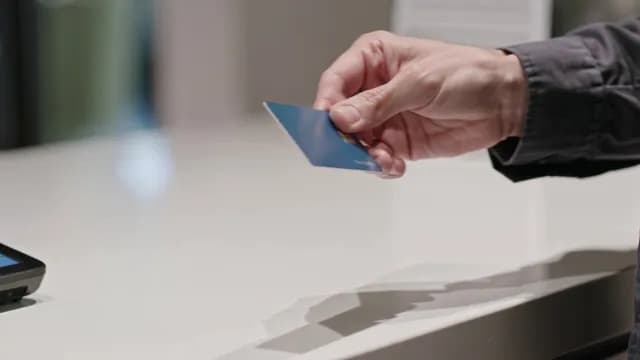 Close-up of Customer Making a Credit Card Payment at Checkout Counter