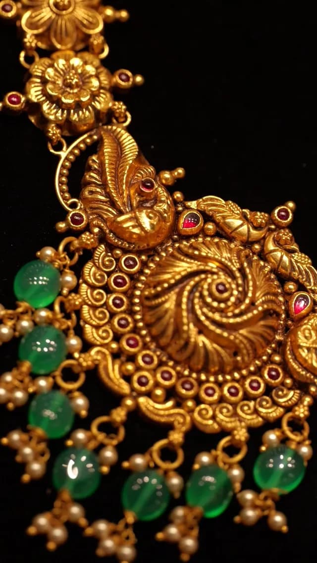 Intricate Traditional Indian Gold Jewelry with Green Beads and Red Stones