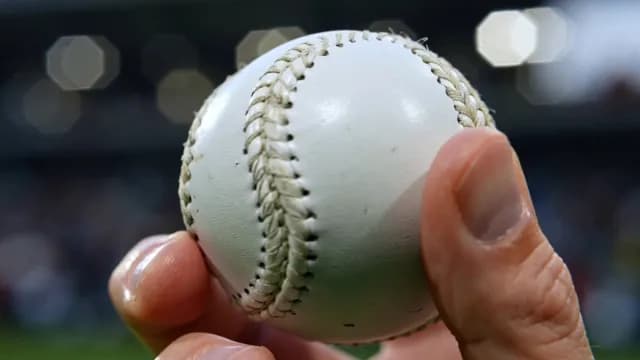 Close-up of Hand Holding a Baseball in a Stadium