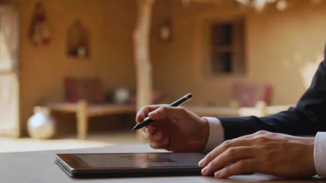 Businessman Working on Tablet in Traditional Village Setting