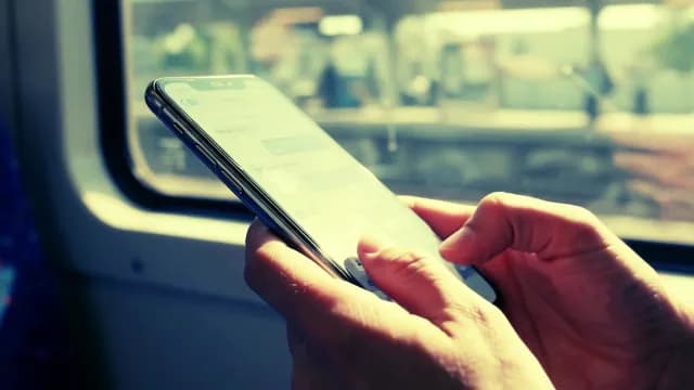 Commuter Messaging on Smartphone During Train Journey