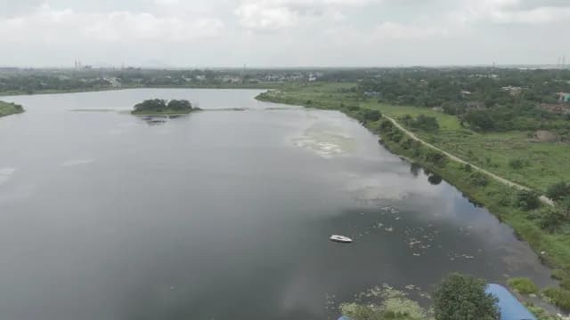 Aerial View of a Scenic Lake with Small Island and Boat - S-Log Footage
