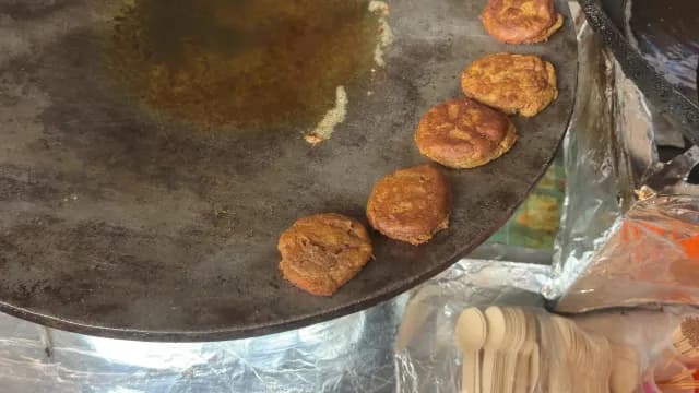 Indian Street Food Patties(Tikki) Sizzling on a Large Flat Griddle