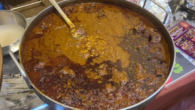Authentic Indian Mutton Curry Simmering in a Large Traditional Pot