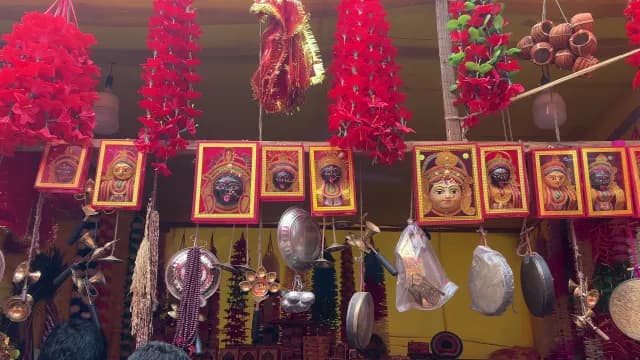 Traditional Hindu Religious Items and Deity Portraits at an Indian Market Stall