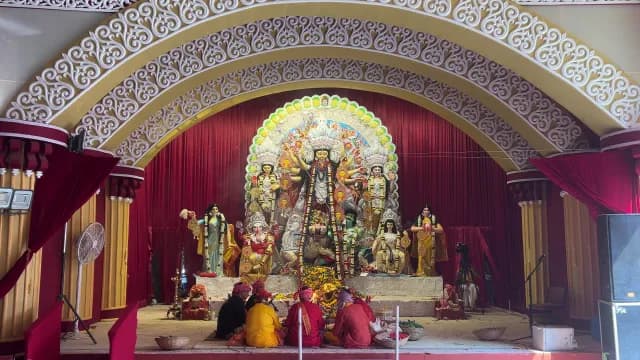 Ornate Goddess Durga Idol and Devotees at Durga Puja Festival Pandal